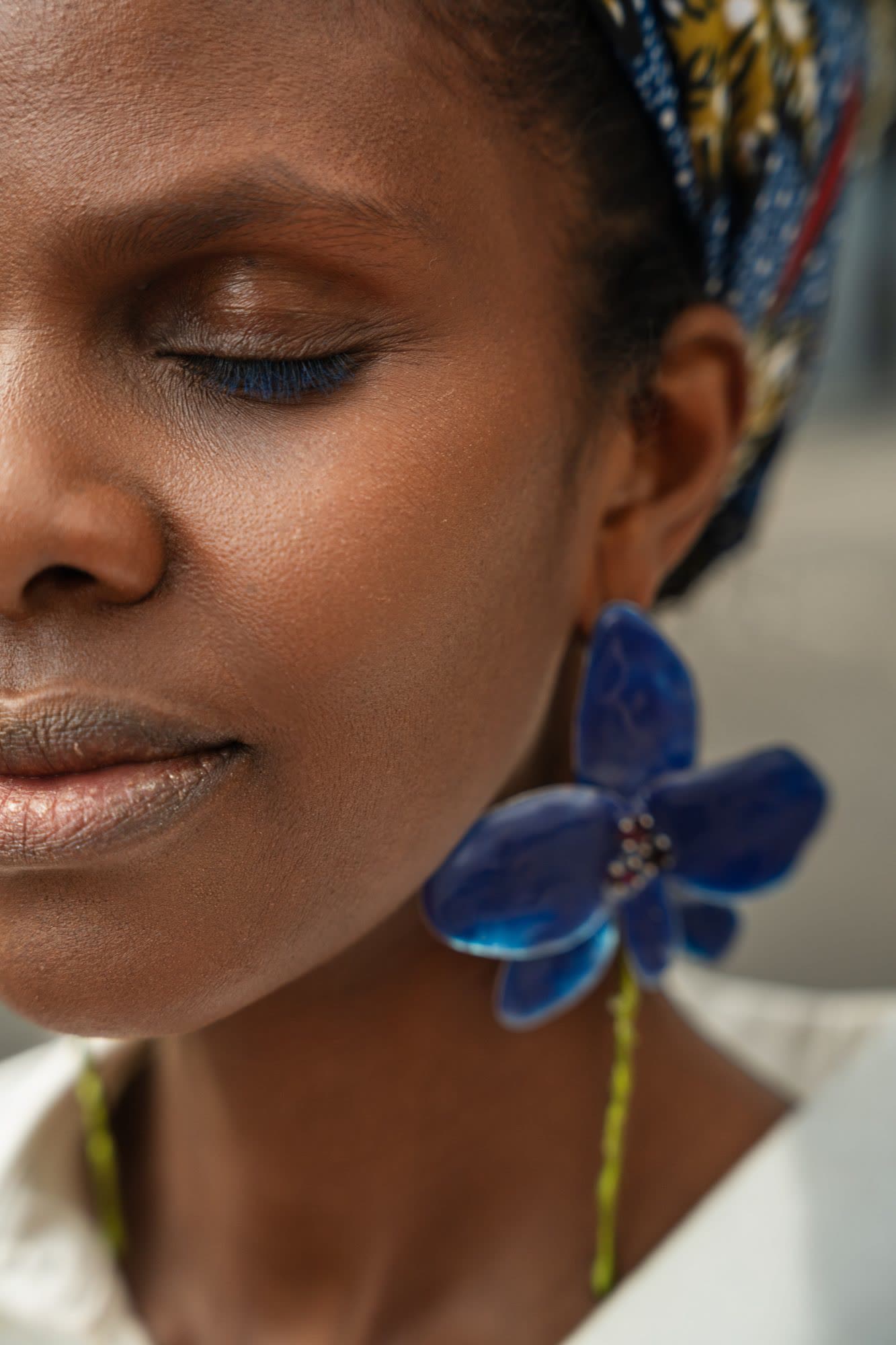 Detail of an earring and printed cotton